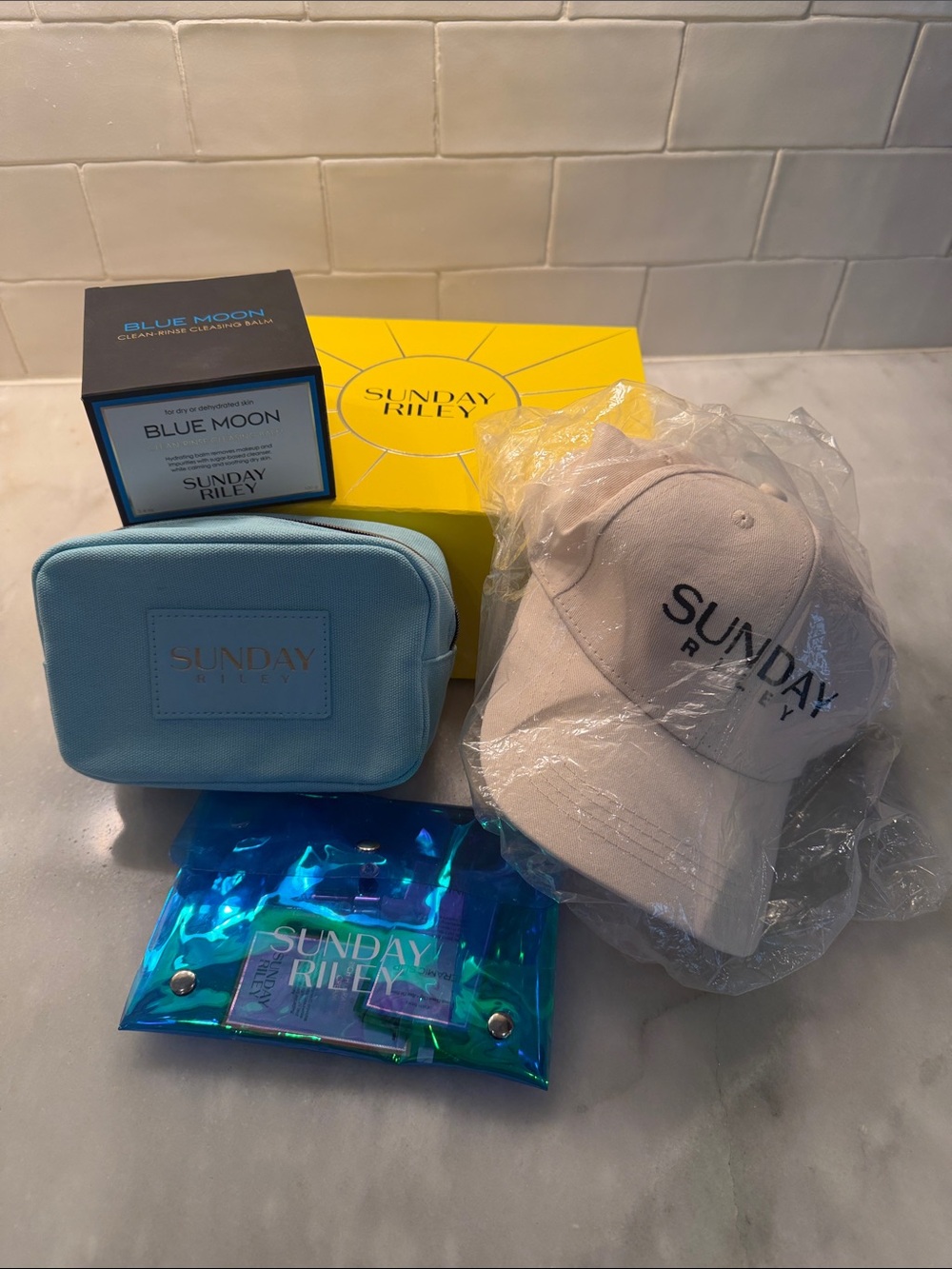 Sunday Riley Blue Moon, Cap, Cosmetic Bags, Branded Towel & Clips and Samples